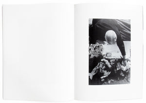 Interior view of Larry Clark's "Tulsa", with photograph of man putting baby in coffin.