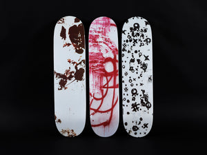 Image of three silkscreen printed skateboard decks by Christopher Wool.
