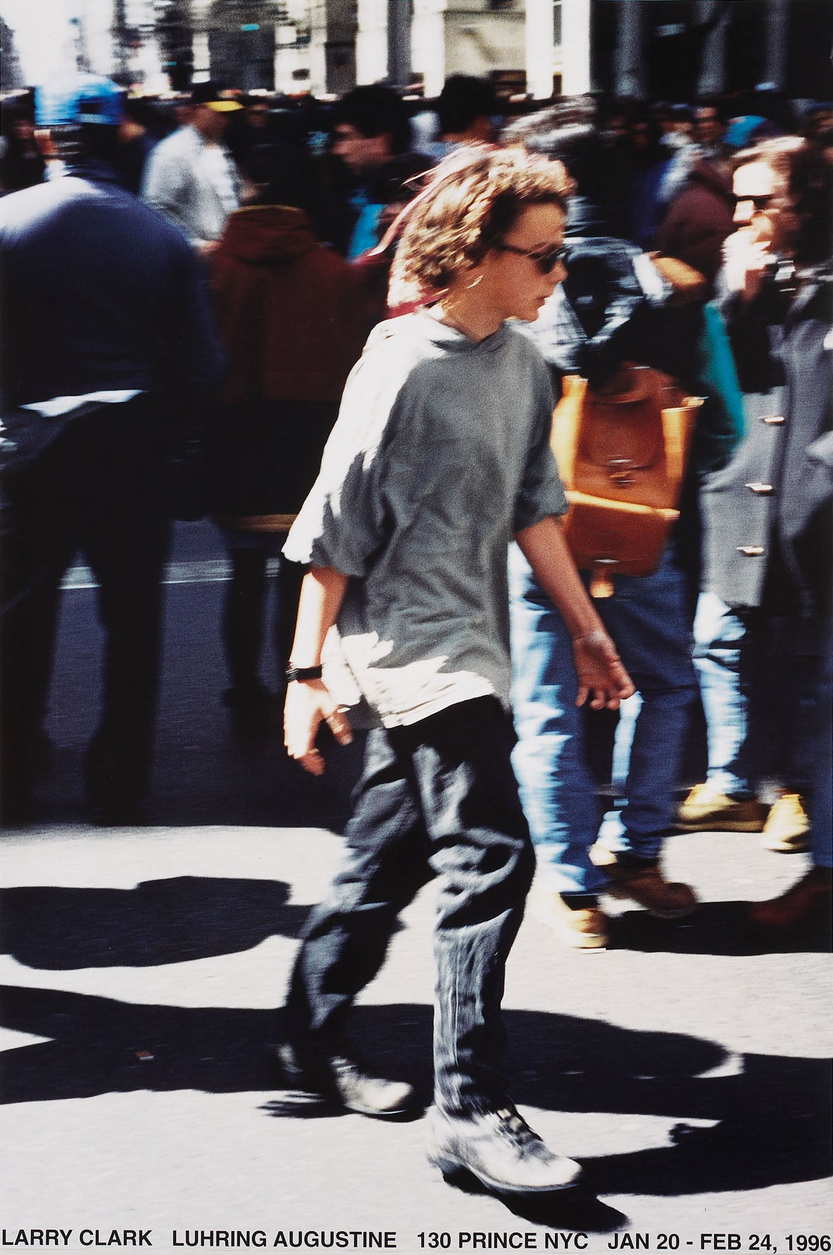 Poster from Larry Clark's 1996 exhibition, featuring a photograph of a youth walking on the street through a crowd. 