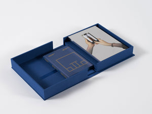 Image of interior of boxed set by Michelangelo Pistoletto with silkscreen on steel and book.