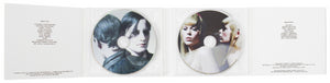 Image of interior of DVD of Charles Atlas' documentary "Turning." Image shows two disks with the faces of women printed on them as well as music and "beauties" credits. 