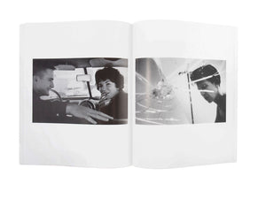 Image of the inside of the photograph book from Larry Clark's "Kiss the Past Hello" set. Image on the left is of a man and woman in the front seat of a car, image on the right is the reflection of a man in a shattered surface.