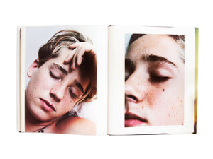 Interior view of Larry Clark's "The Perfect Childhood", with two portraits of young blond boy. 