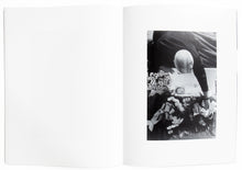 Load image into Gallery viewer, Interior view of Larry Clark&#39;s &quot;Tulsa&quot;, with photograph of man putting baby in coffin.