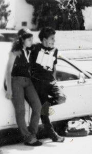 Poster from Larry Clark's 2014 exhibition titled ""they thought i were but i aren't anymore," featuring a blurry black and white photograph of a young couple leaning against a car.