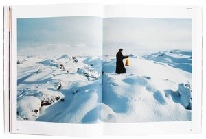 Image of interior of Ragnar Kjartansson's book "Barbican," with a two-page image of a man in the snow pointing a rifle. 