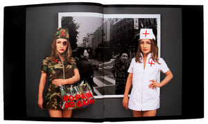 Image of the inside of Yasumasa Morimura's "No Pain, No Gain" exhibition catalog, with a two-page full spread photograph of a work by the artist.